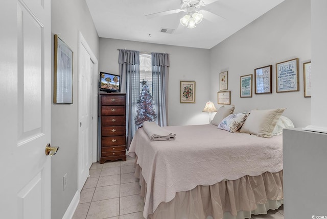 tiled bedroom featuring a closet and ceiling fan