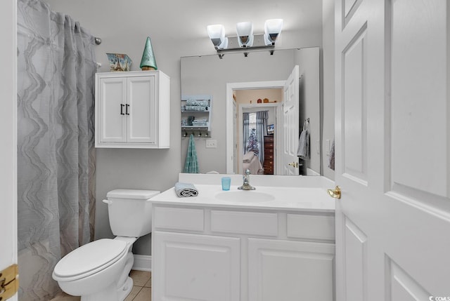 bathroom with tile patterned floors, vanity, and toilet