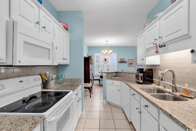 712 Algonquin Dr Unit A, Pawleys Island, SC 29585 - kitchen with white appliances, a chandelier, white cabinetry, decorative backsplash, and light tile patterned floors