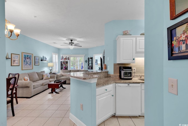 kitchen featuring dishwasher, tasteful backsplash, light tile patterned flooring, kitchen peninsula, and white cabinets