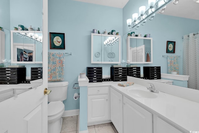 bathroom with tile patterned flooring, vanity, and toilet