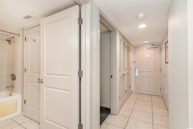 hallway featuring light tile patterned floors