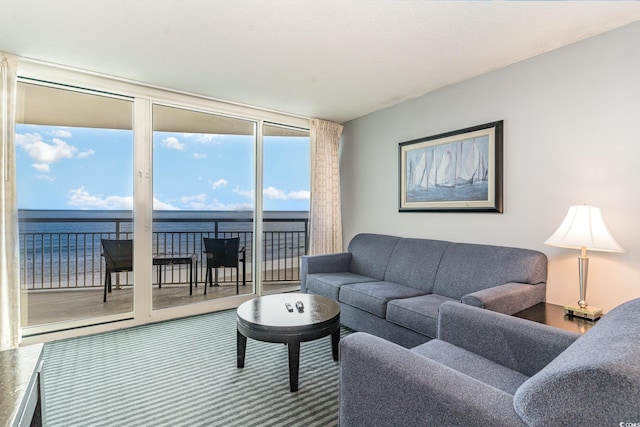 living room with expansive windows and a water view