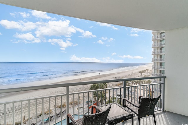 balcony with a view of the beach and a water view