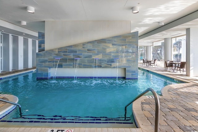 view of swimming pool featuring pool water feature and a patio area