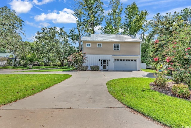 613 Lee Ave, Murrells Inlet, SC 29576 - view of front of house featuring curved driveway, an attached garage, a front yard, and metal roof