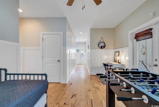 613 Lee Ave, Murrells Inlet, SC 29576 - bedroom featuring a decorative wall, wainscoting, light wood-style flooring, and ceiling fan
