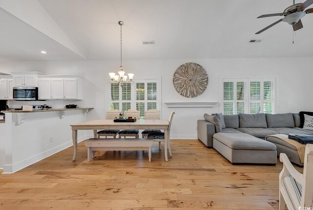 613 Lee Ave, Murrells Inlet, SC 29576 - dining space with a ceiling fan, a chandelier, vaulted ceiling, light wood-type flooring, and recessed lighting