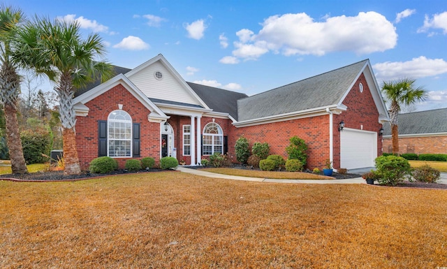 view of front property featuring a front lawn and a garage