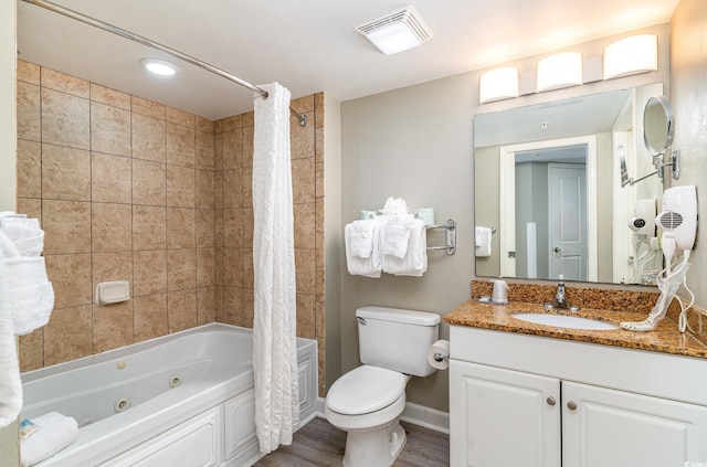 full bathroom featuring hardwood / wood-style floors, vanity, shower / bath combo, and toilet