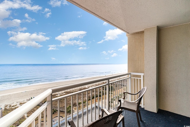 balcony with a beach view and a water view