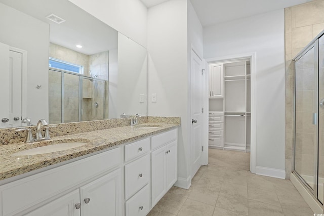 bathroom featuring walk in shower and vanity