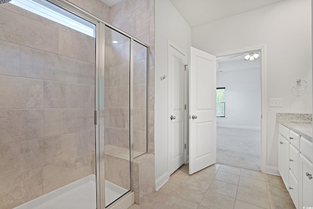 bathroom with vanity, tile patterned flooring, plenty of natural light, and walk in shower