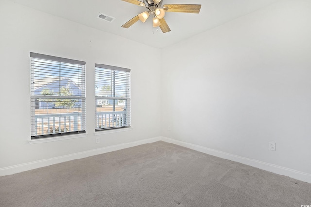 carpeted empty room featuring ceiling fan