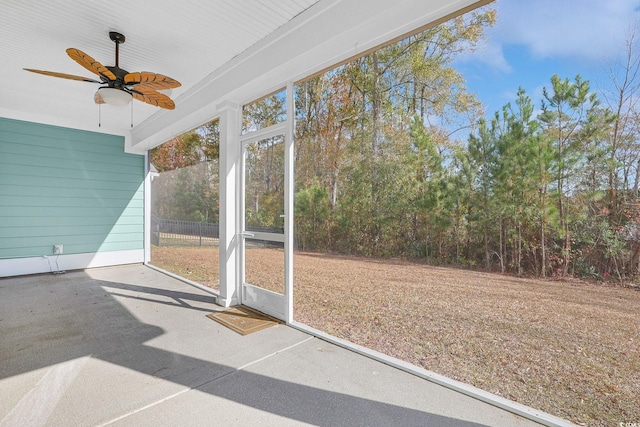 unfurnished sunroom with ceiling fan and a healthy amount of sunlight