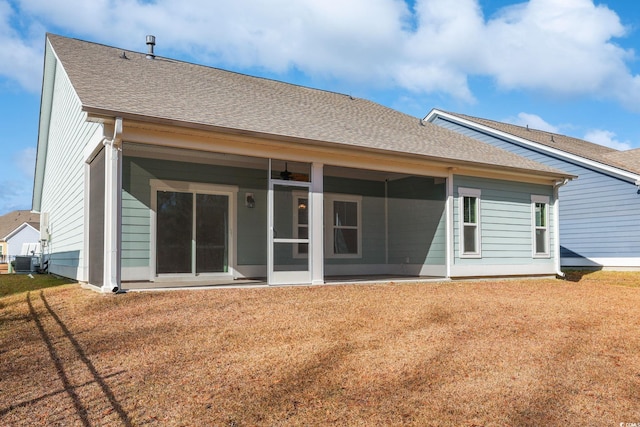 rear view of property featuring ceiling fan, a sunroom, cooling unit, and a yard