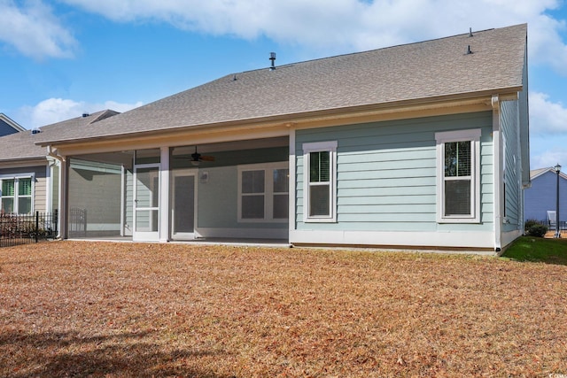 back of house with a lawn, ceiling fan, and a sunroom