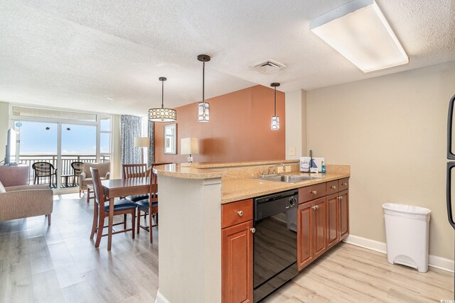 kitchen with sink, kitchen peninsula, black dishwasher, and hanging light fixtures