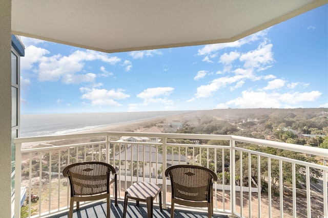 balcony with a beach view and a water view