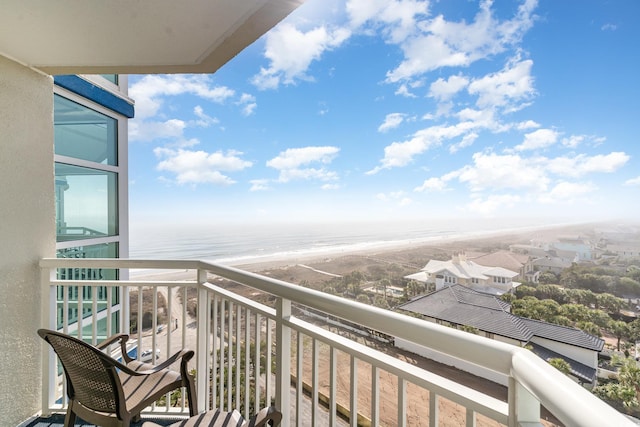 balcony featuring a water view and a view of the beach