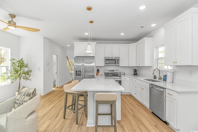 210 26th Ave S, Myrtle Beach, SC 29577 - kitchen featuring white cabinets, a kitchen breakfast bar, stainless steel appliances, and a sink
