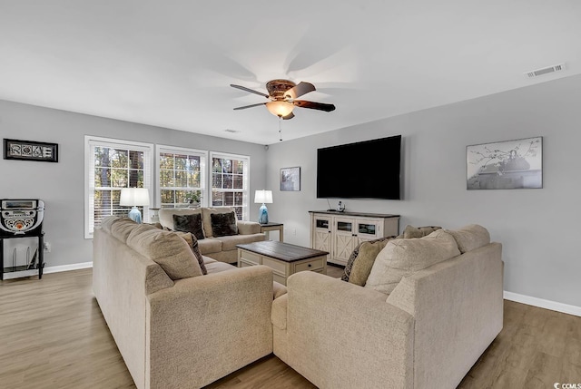 living room featuring ceiling fan and light wood-type flooring