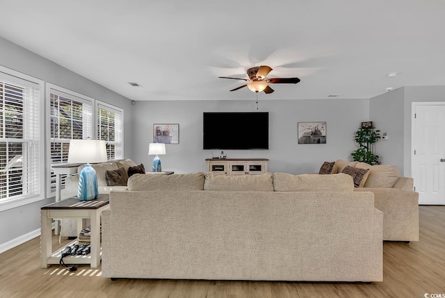 living room featuring ceiling fan and light wood-type flooring