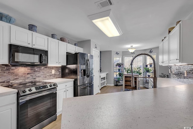 kitchen featuring stainless steel appliances and white cabinets