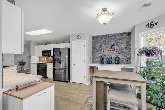 kitchen featuring white cabinetry, backsplash, electric range, fridge with ice dispenser, and light wood-type flooring