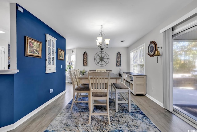 dining room with a notable chandelier and hardwood / wood-style flooring