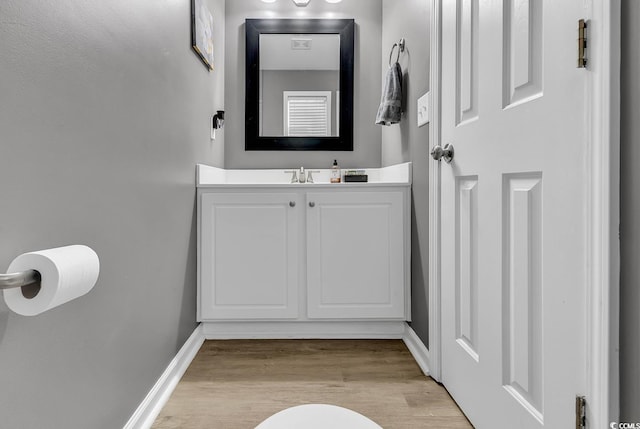 bathroom with vanity and wood-type flooring