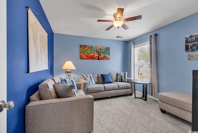 carpeted living room featuring ceiling fan