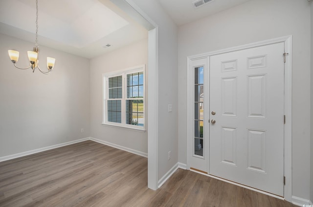 foyer featuring an inviting chandelier and wood-type flooring