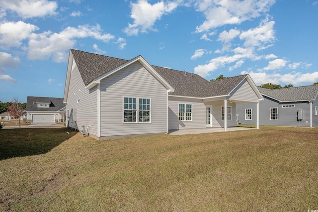 back of property featuring a patio and a yard