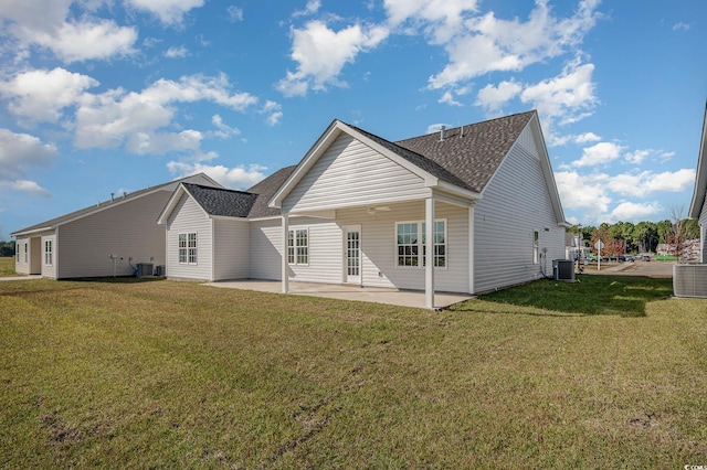 rear view of property with a yard, central air condition unit, and a patio area