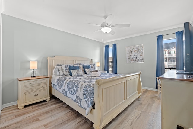 bedroom featuring ceiling fan, light hardwood / wood-style floors, crown molding, and multiple windows