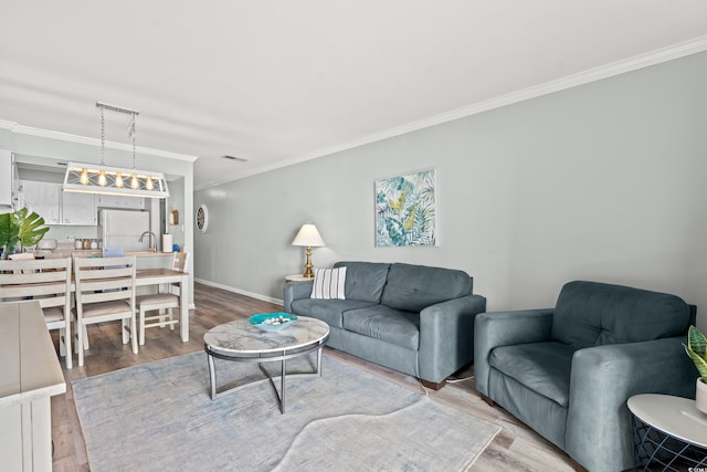 living room featuring hardwood / wood-style floors and ornamental molding