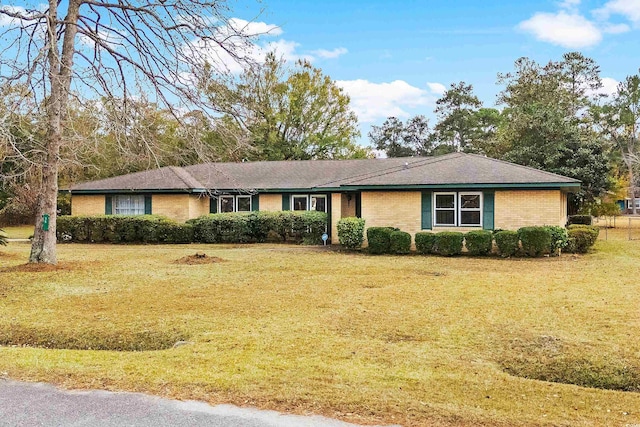ranch-style home with brick siding and a front yard