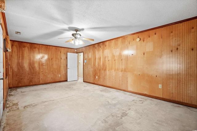 unfurnished room with a textured ceiling, ceiling fan, and crown molding