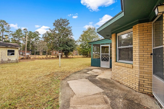 view of yard with a patio area and a sunroom