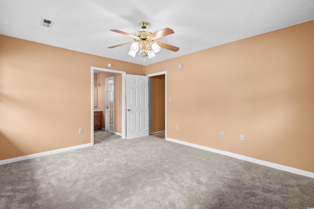unfurnished bedroom featuring baseboards, visible vents, and light carpet
