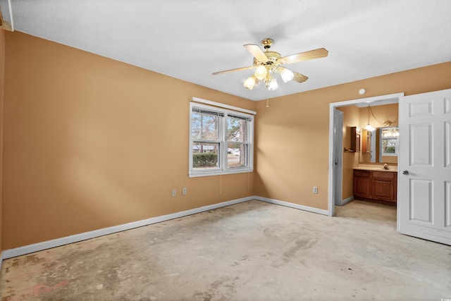 unfurnished bedroom featuring ensuite bathroom and ceiling fan