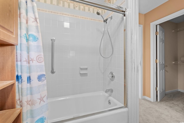 bathroom with shower / tub combo with curtain and baseboards