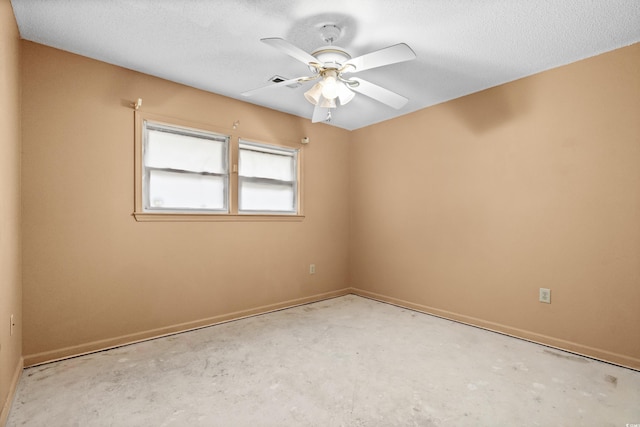 empty room featuring ceiling fan and a textured ceiling