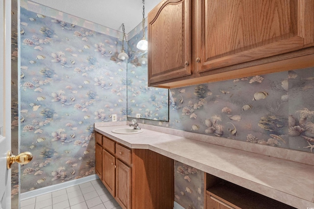 bathroom featuring tile patterned flooring, vanity, and baseboards