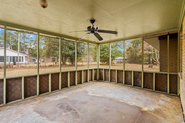 unfurnished sunroom with a ceiling fan