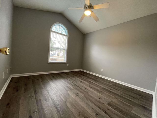 unfurnished room with ceiling fan, dark wood-type flooring, and lofted ceiling