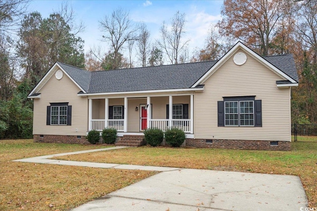 ranch-style house with a front yard and covered porch