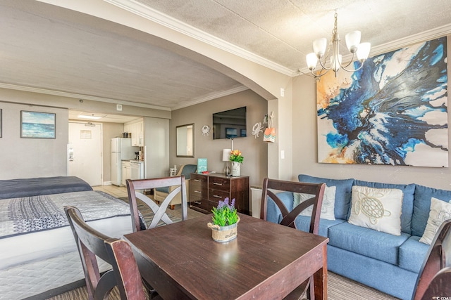 dining area featuring a textured ceiling, an inviting chandelier, and crown molding