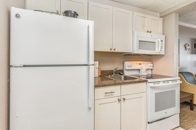 kitchen featuring white cabinets, crown molding, white appliances, and sink